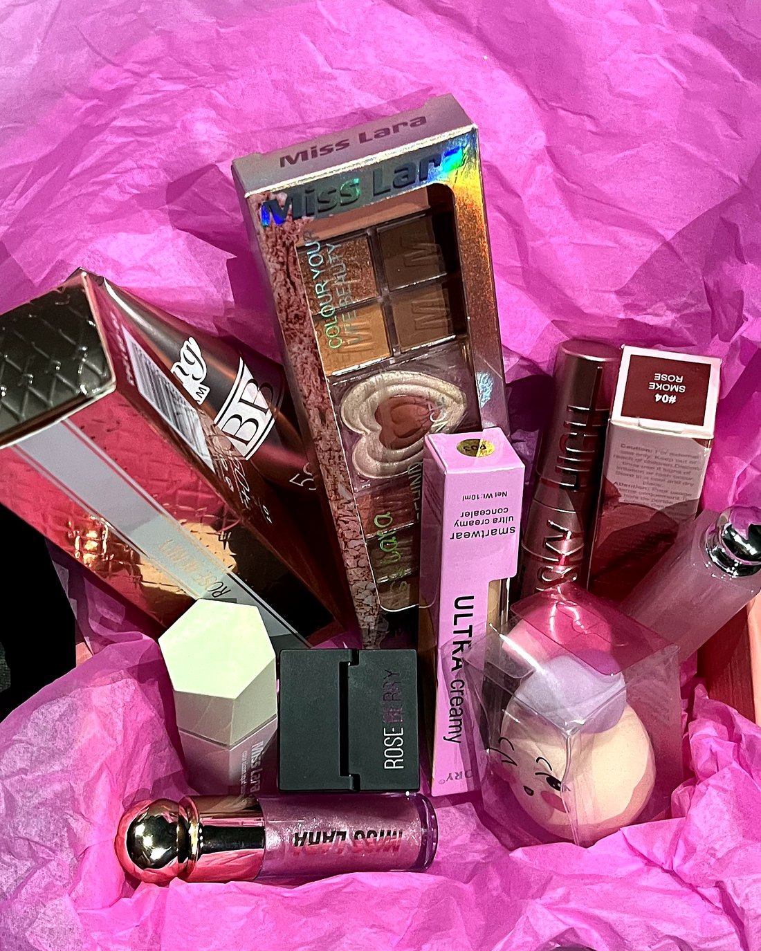 Everything inside the Nayle Beauty Box, wrapped in pink tissue